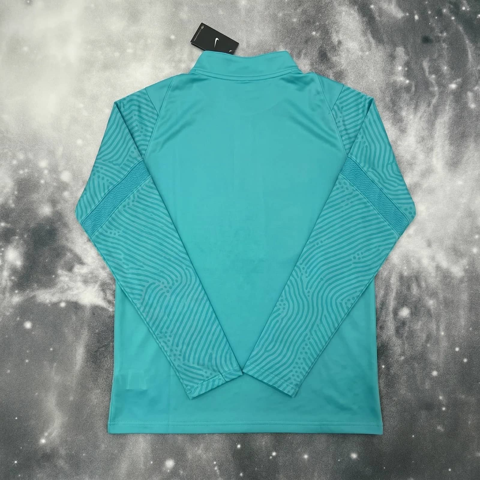 Dos du pull zippé bleu turquoise Brésil à plat, maille gaufrée