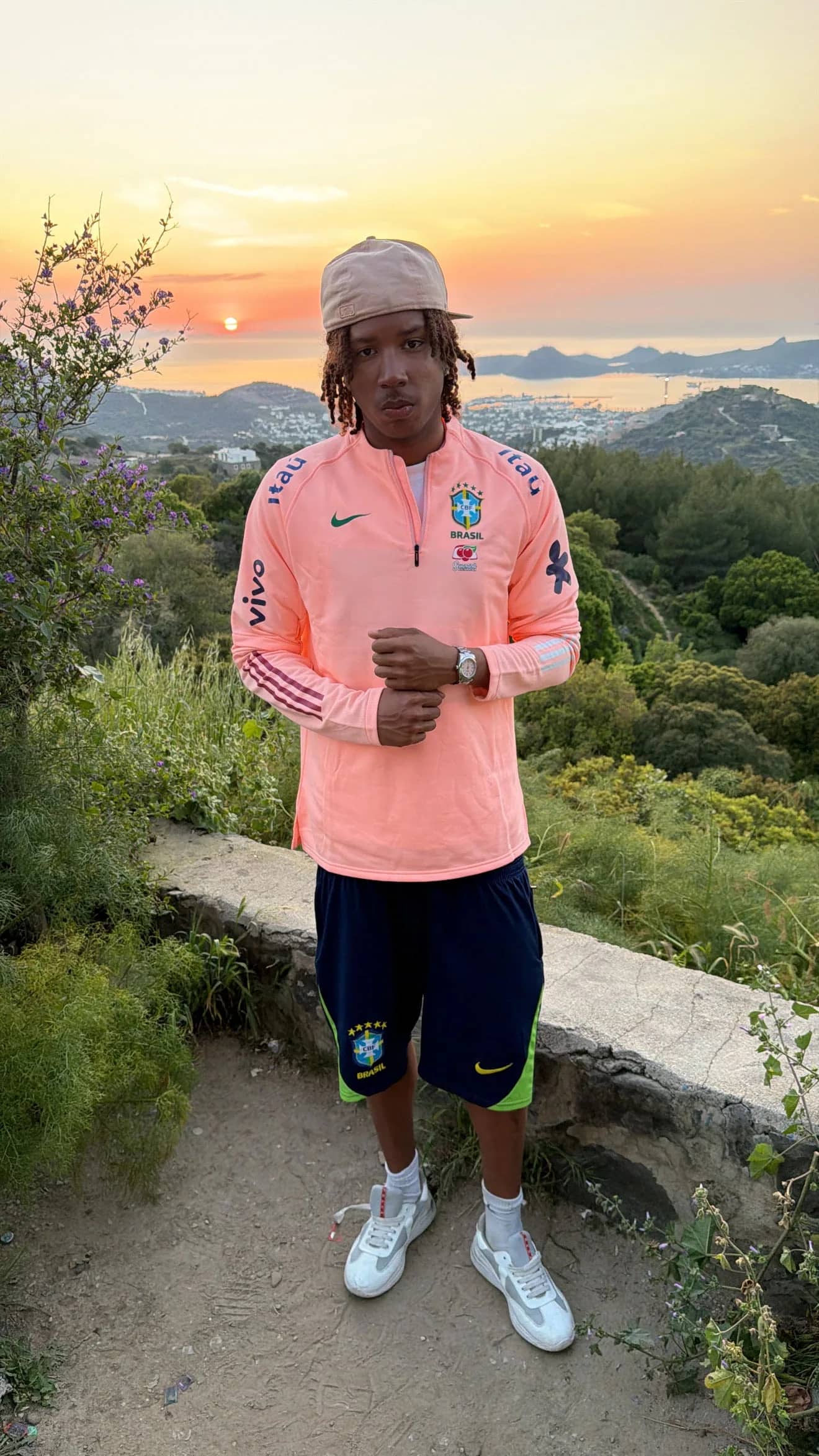 Homme portant le pull zippé rose saumon Brésil au coucher du soleil